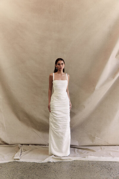 black and white image bride wearing strapless satin wedding dress with long train