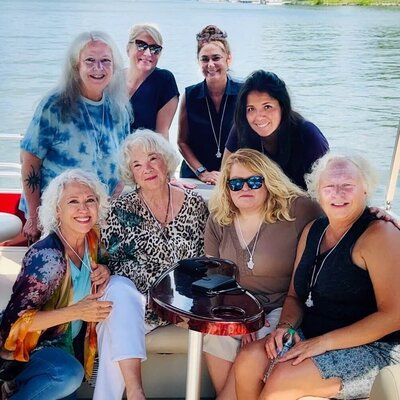 Samarah Grace and 7 women sitting on boat during reiki retreat