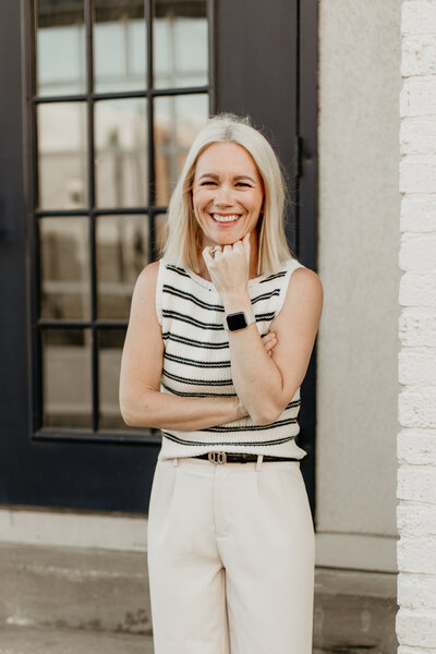 Woman laughing during a candid branding photo session.