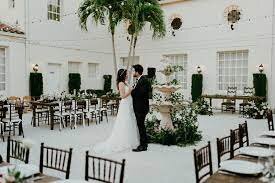 wedding couple holding each other in courtyard