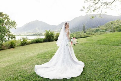 A person in a wedding dress looking over their shoulder and smiling 