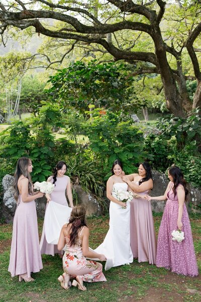 A wedding party adjusting a wedding participants dress 