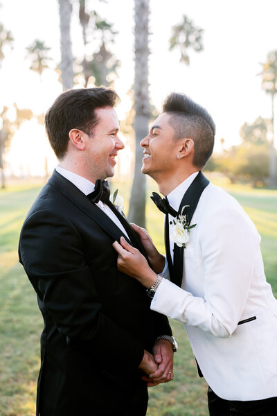 Same sex couple smile with excitement on their wedding day at Hilton Santa Barbara Resort
