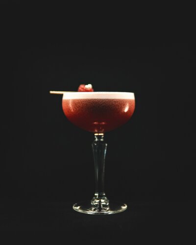 frothy cocktail in martini glass