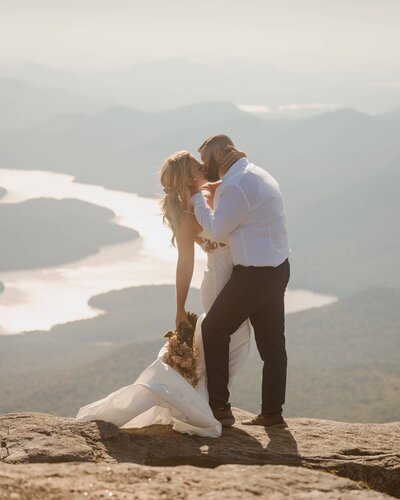 Their first kiss on top of Whiteface Mountain as newlyweds.