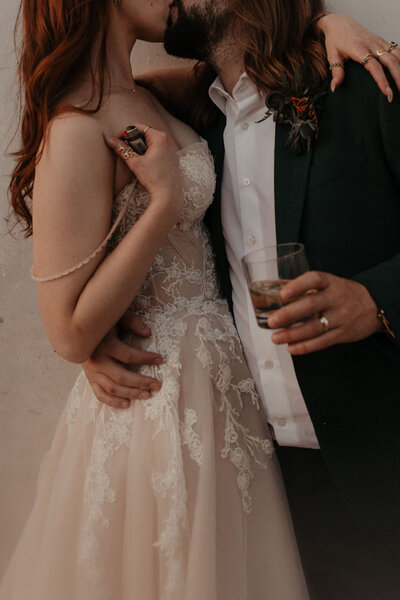 bride and groom embrace at wedding reception