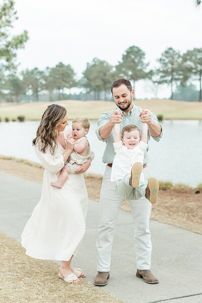family with toddlers playing for family photos near Greenville, NC