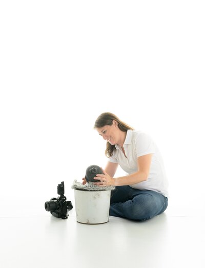 Becky Furry owner of Always Images Photography Studio working with a newborn baby in her Indiana studio.