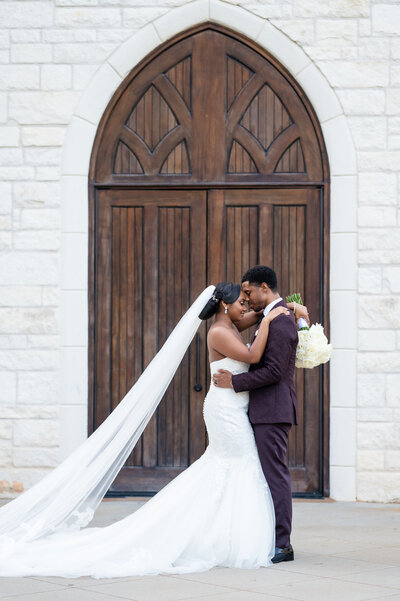 A couple poses for their portrait at Ashton Gardens in Sugar Hill, GA