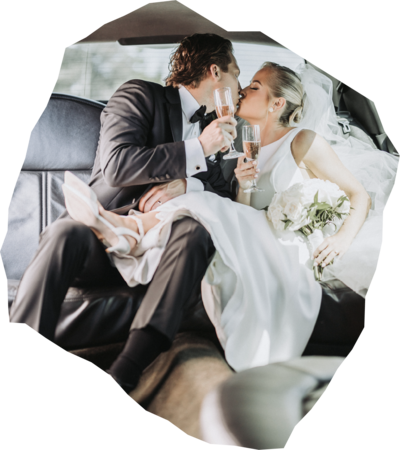 Bride and groom holding champagne kiss in back of limo - professional photo edit