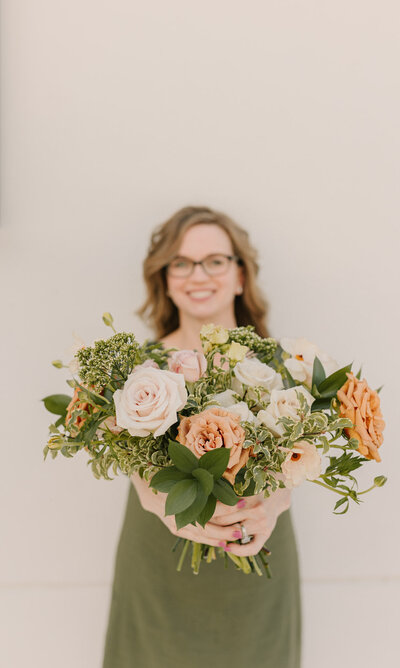 Kendra holding a wedding bouquet