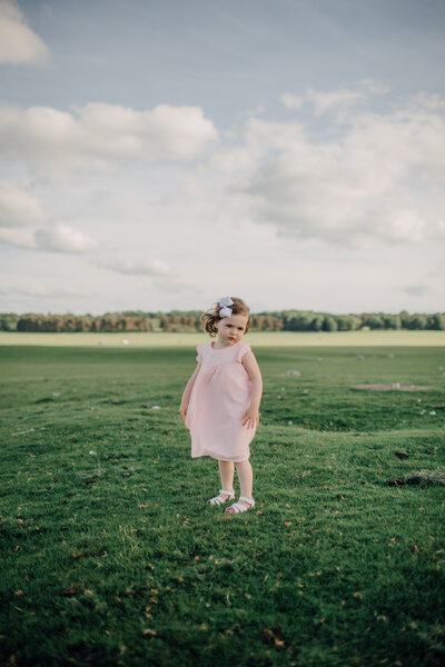 little-girl-in-pink-dress-with-bow-in-hair