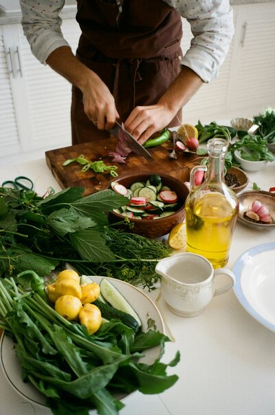 Woman chopping vegetables and making a salad