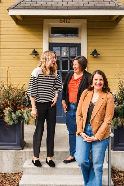 two women standing together smiling