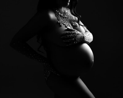Editorial black and white maternity image featuring crystal-studded gloves and dramatic lighting – Austin maternity photographer