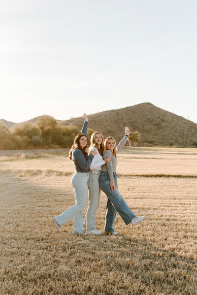 High school senior best friend photo session in a field