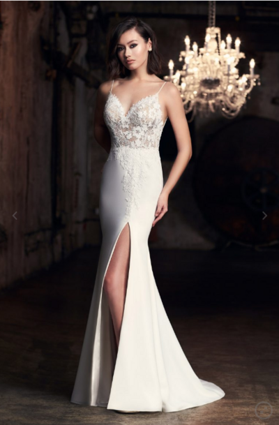 This feminine straight-cut gown is elegant and classy. The Chantilly Lace bodice features the most delicate lace appliqué that extends from the bodice down to the side slit in the front, and along the centre back of the dress. The back of the gown has a flattering low cut with simple spaghetti straps. The fit-and-flare skirt accentuates your figure, giving you a slender silhouette.