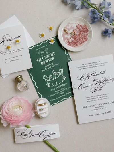 Elegant wedding invitation suite flat lay with floral accents and personalized details.
