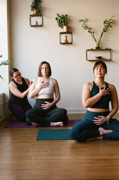 A pregnant woman practicing prenatal yoga on a mat in Evanston, IL, promoting relaxation and wellness for her and her baby.