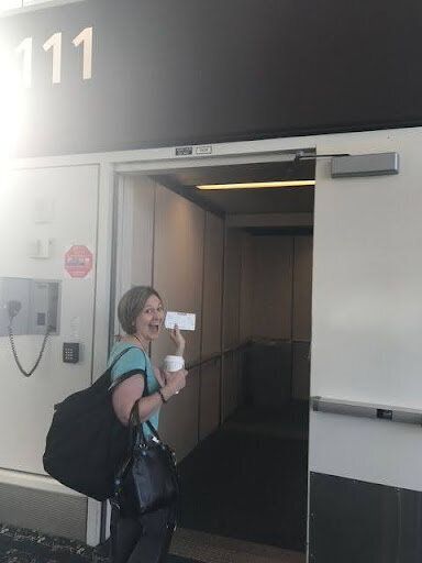 Keri holding boarding pass as she is boarding the plane to SoCal