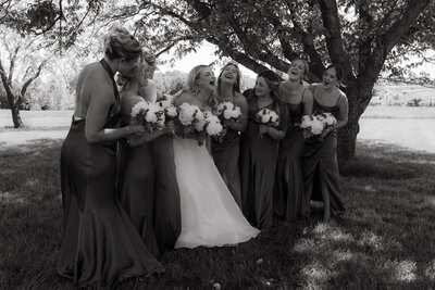 groomsmen laugh over drinks after columbia mo wedding