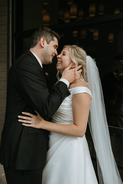Bride and groom laughing close together  taken by fargo wedding photographer kiella lawrence