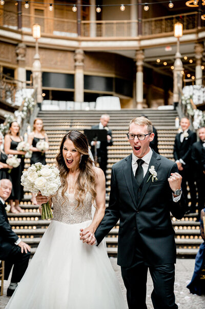 bride and groom excited after Hyatt Regency Arcade wedding