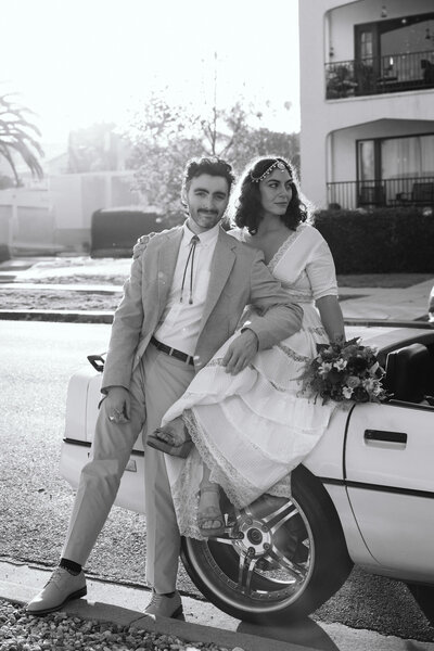editorial photograph of a bride and groom and their getaway car captured by Southern California film and digital documentary wedding photographer