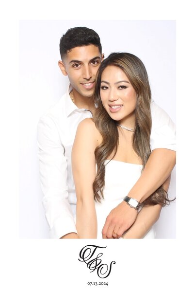 Couple posing together for wedding photo booth