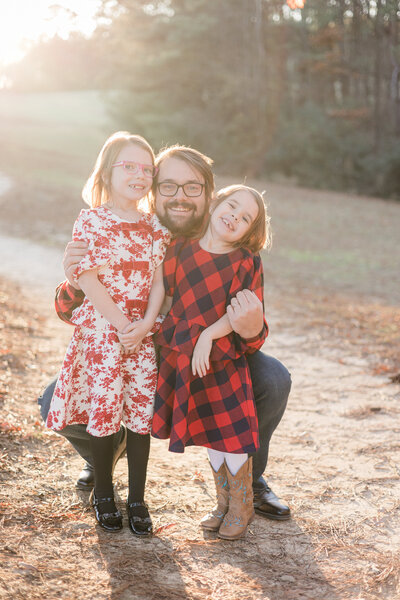 Female on back of sister smiling at the camera.