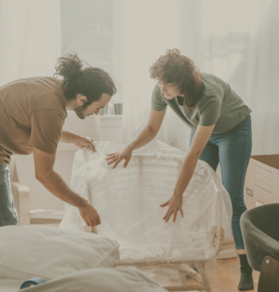 A man and woman preparing  their home and packing furniture to move up to their next Northern Colorado Home