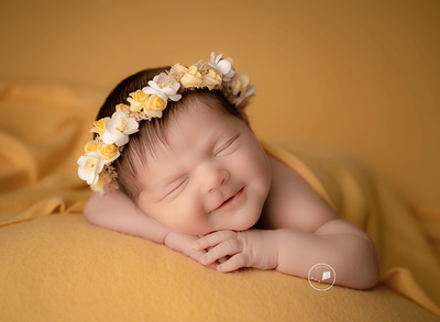 baby girl smiling in newborn session