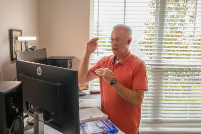 Mark Sullivan wearing a orange shirt in his office coaching a client on Zoom – Life and Health Coach at LifeNBalance Coaching20