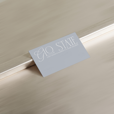 Glo State Experiences Business card on silver wall and floor