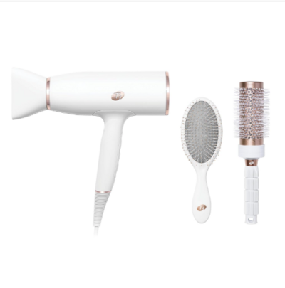 A white and rose gold T3 AireLuxe blow dryer displayed with a matching vented brush and paddle brush. The set combines high-tech styling with a luxe aesthetic for smooth, frizz-free results.