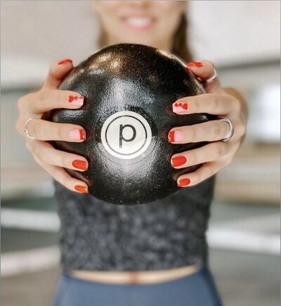 woman holding resistance workout ball