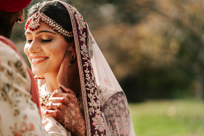 Bride can't help but smile during at their Planting Fields Arboretum wedding in Oyster Bay, New York