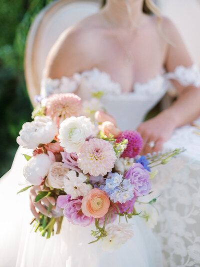 Bride holds romantic wedding bouquet during her upscale wedding in Paso Robles ca.