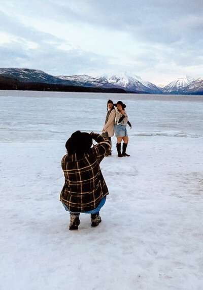 Photographer taking photos on a snowy lakeshore