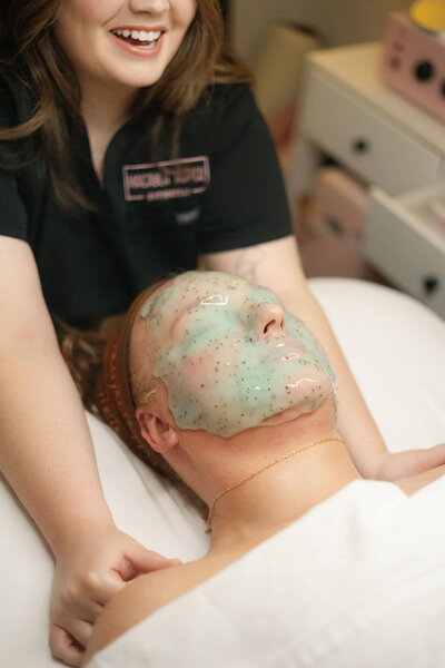 Client recieving shoulder massage while jelly mask cures during facial service at Macayla Hopper Esthetics Hartselle 