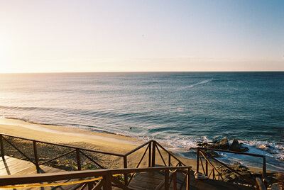 Scenic landscape photo of the beach and ocean taken from boardwalk steps