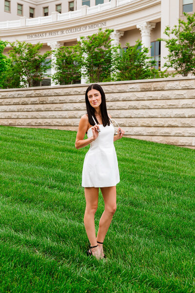 Graduating girl holding stethoscope outside of Belmont University medical college