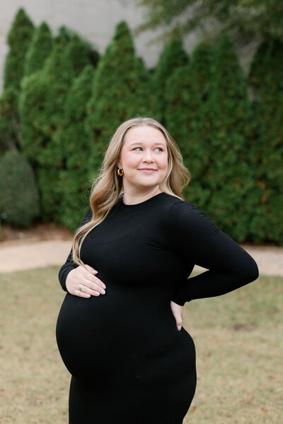 Pregnant woman smiling for maternity photos