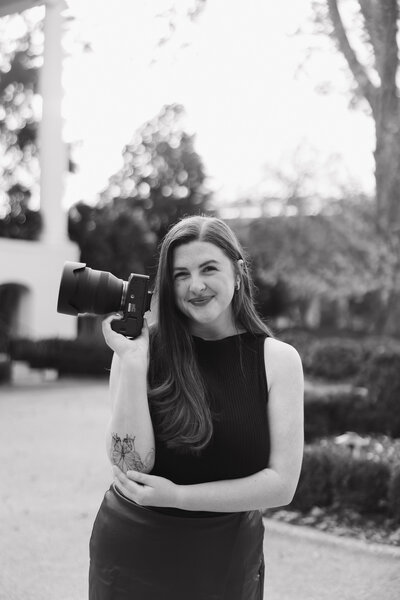 Alabama wedding photographer holding camera at President’s Mansion