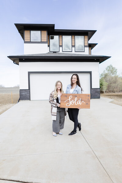 Realtor Tamara Rzan celebrates a successful home sale with her client.
