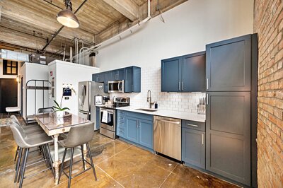 Bright and airy dining room and kitchen in a 4-bedroom, 2-bathroom vacation rental condo in downtown Waco, TX