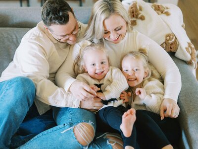 twin girls playing with their parents