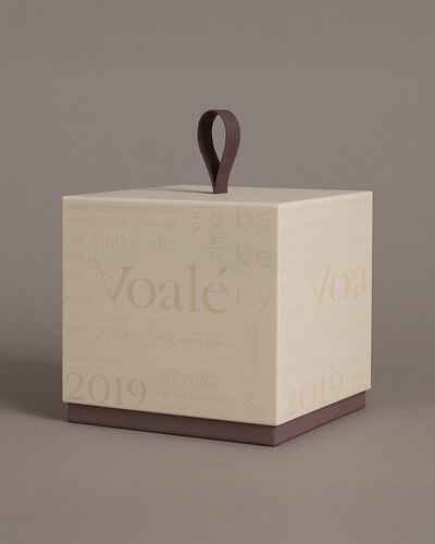Voalé packaging design featuring cream cube box with embossed typography and purple handle, showcasing premium brand materials.