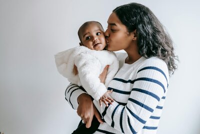 Woman kissing her baby's cheek
