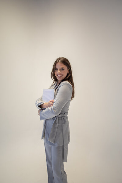 woman leaning against wall while smiling